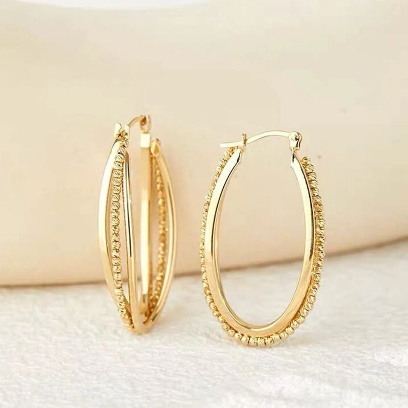 Aros de triple cercle en or massís de 18 quirats Les Accessoires